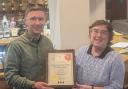 Jacob Yuill receives the award from Keighley and Craven CAMRA branch representative Jenny Baker