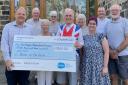 Andrew Wood, left, community fundraising manager at Manorlands, receives a cheque from William Jowitt and the Silsden Proms on the Farm organising committee