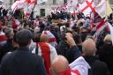 People waving flags during the St George’s Day rally (Jordan Pettitt/PA)