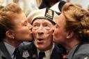D-Day veteran Alec Penstone, 98, receives a kiss from the D-Day Darlings at the D-Day 80 launch event (Gareth Fuller/PA)