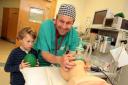 Alfie Swinton helps his dad Dr Frank Swinton, a consultant anaesthetist, during the open day at Airedale Hospital's operating theatres