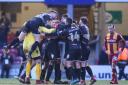 George Miller celebrates with his Bury team-mates after his last-gasp leveller – Picture: Thomas Gadd