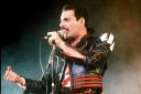 FILE - In this 1985 file photo, singer Freddie Mercury of the rock group Queen, performs at a concert in Sydney, Australia. Queen guitarist Brian May says an asteroid in Jupiter's orbit has been named after the band's late frontman Freddie