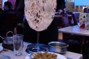 Serving up one of the giant naan breads at the Shimla Spice restaurant in Keighley