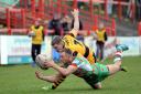 Keighley Cougars' James Craven has his eyes on the ball under pressure from Wath Brow Hornets' Mark Watson