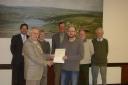 Oxenhope Parish Council members receive their Quality Parish Council re-accreditation certificate from Worth Valley district councillor Peter Hill,