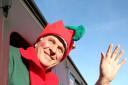 Santa’s helper, Richard Lamb, waves to the crowds of visitors at Oxenhope Station for the Santa Special service