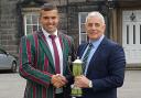 From left, former student, Leicester Tigers ace James Whitcombe, is presented with Woodhouse Grove School's Burnhill Cup by Steve Burnhill