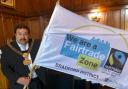 Lord Mayor of Bradford, Cllr Shabir Hussain, with the Fairtrade zone flag