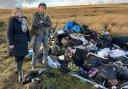 Councillor Rebecca Poulsen and farmer Walter Clay, with some of the rubbish dumped on his land