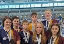 Denholme's Amy Hagyard (left) and Keighley's Quinn Austin-Kelly (third left) were among the City of Bradford swimmers to shine in Sheffield.