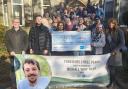 Family and friends of Michael present a cheque to Manorlands