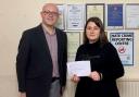 Adrian Farley presents a cheque to Dorota Plata, of The Good Shepherd Centre