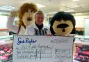 Lamby and Beefy, representing Keelham Farm Shop, hand over their cheque to Manorlands