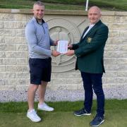 Joe Copperwaite (left) being presented with his course record scorecard by Branshaw's club president Steve Buckley.