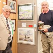 2019 show president Mike Cunningham, left, presents a trophy to an art section winner