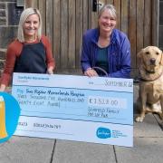 Manorlands' Hayley Ibbotson, left, receives a cheque from Sarah Schofield