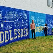 Some of the artists in front of the mural