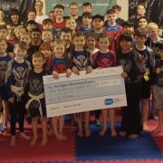 Keighley Martial Arts Centre members with a cheque for Manorlands