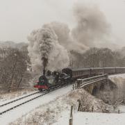 A loco makes its way along the line as snow falls