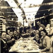 Residents of Back Emily Street enjoying an outdoor tea party on the Sunday before the Coronation Day in 1953