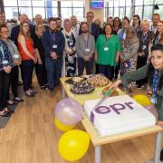 Airedale EPR trainer Gergana Mihova cuts a special celebratory cake at a launch event, with trust chief executive Foluke Ajayi, representatives from Oracle Cerner and members of the EPR team