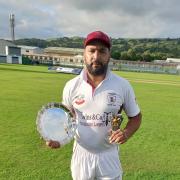 Mohammed Gulnawaz proudly holds the Manorlands Plate and the man of the match award.