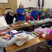 Volunteers hard at work wrapping the gifts