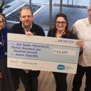 Andrew Wood, second from left, receives a cheque from Acorn Stairlifts representatives Emily Shepherd, left, Kate Gledhill and Jonathan Sutcliffe-Bland