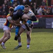 Ben Stead (left) and team-mate Charlie Graham put in a ferocious tackle during Keighley Cougars' narrow 1895 Cup defeat to neighbours Bradford Bulls back in February.