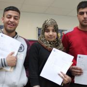 University Academy Keighley's top students Shamraiz Ashfaq, Rukhsaar Akhtar and Bilal Hayat pick up their results