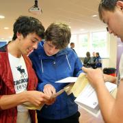 James Figg, left, Adam Beazley and James Meehan, right, check their results at South Craven School