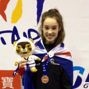 Leah Moorby shows off her Junior World Championship bronze medal and memento