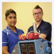 Senior charge nurse Richard Rees-Jones with staff nurse Qusva Ilyas and one of the outdated cardiac monitors the appeal will help replace
