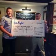 Manorlands fundraiser, Matthew Binns, collects the cheque from David Whitehead at Haworth Old Hall