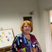 Angel Kershaw demonstrating the art of oil painting