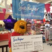 Emma Kinsey and 'honey monster' Daniel Green with the cheque for Manorlands