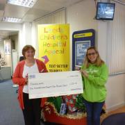 Debbie Ergene, left, from the Halifax, presents a cheque to Manorlands fundraising assistant Jodie Batters