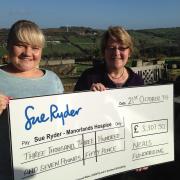 Kath Neal and daughter Jenny with their cheque for Manorlands