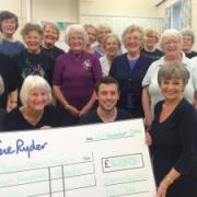 Manorlands fundaiser Matthew Palmer accepts a £400 cheque from members of Cononley Ladies Keep Fit Group