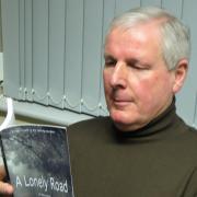 Peter Morrison with his first novel A Lonely Road