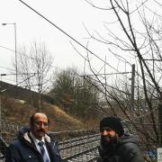 Councillor Zafar Ali, left, and Shahid Rasool at the spot where people are endangering their lives crossing the railway line