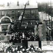 A crowd watches the library stone-laying ceremony on the building site in its early stages