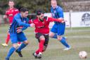 Silsden's Khurram Shazad (red) scored a first-half treble in their huge victory. Picture: David Brett.
