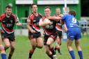 Connor Meegan (ball in hand) was one of eight Albion players to score a try as they won their season opener impressively at Sharlston Rovers.