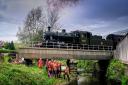 A steam train passes during the River Worth clean up