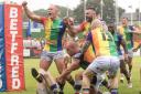Keighley Cougars players celebrate a try against Whitehaven