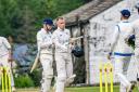Joel Fothergill (helmetless) took 4-18, then won the game for Oxenhope with a six.