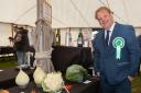 Last year's show president Andrew Wood admires some of the veg exhibits