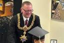 Town mayor Councillor John Kirby makes the presentations to the young graduates